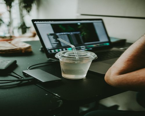 A glass of pure water next to a workstation