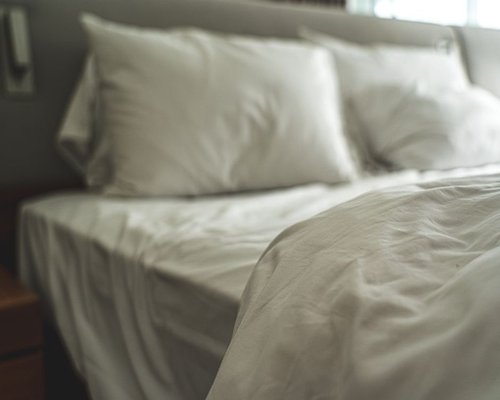 A comfortable clean bed with soft light